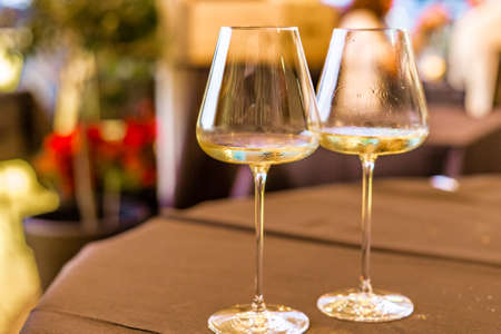 humid white wine goblets on restaurant tableの写真素材