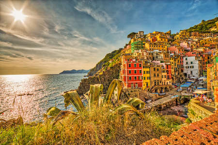 tourists walk in the street of colorful housesの写真素材
