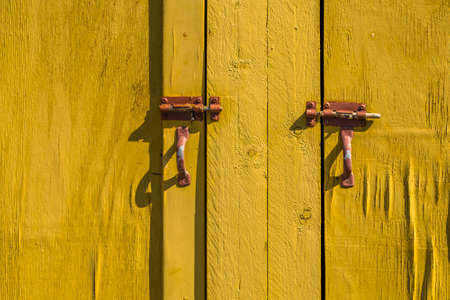 Rusty bolts on an old wooden doorの写真素材