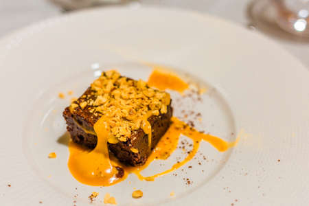 Serving of dessert at the restaurant, chocolate tile