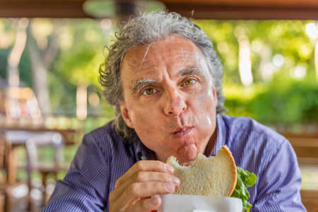 Happy tourist eating organic sandwich in Italian countrysideの写真素材