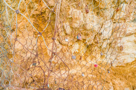 LERICI (SP), ITALY - JUNE 21, 2018: padlocks let by lovers on wire mesh as symbol of loveのeditorial素材