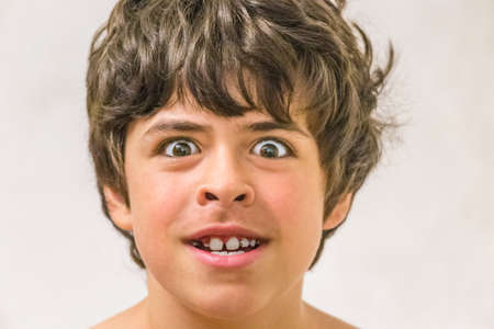 young boy making a funny faceの写真素材