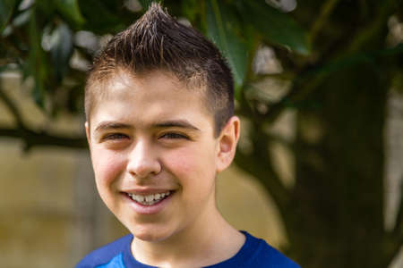 young boy smiling in green garden