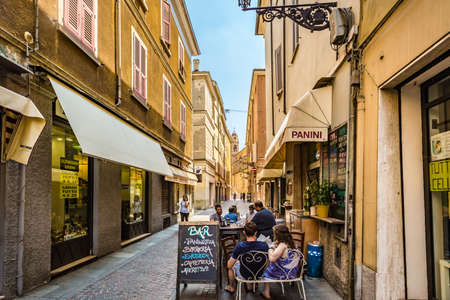 PARMA, ITALY â€“ AUGUST 23, 2018: Tourists are having lunch at restaurant in charming historic...