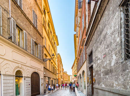 PARMA, ITALY â€“ AUGUST 23, 2018: Tourists are walking and enjoying the charming historic lanes...