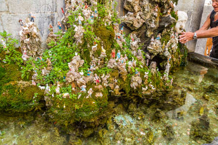 AMALFI (SA), ITALY - AUGUST 29, 2018: water flowing from the taps of the fountain around Nativity sceneのeditorial素材