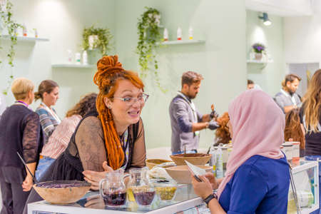 BOLOGNA (ITALY), SEPTEMBER 10, 2018:  Visitor is visiting a stand and asking exhibitor about the products at SANA, international exhibition of organic and natural productsのeditorial素材