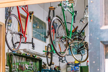 SORRENTO (NA), ITALY - SEPTEMBER 5, 2018: Bicycles are being repaired and hung in the workshop of bicycle mechanicのeditorial素材