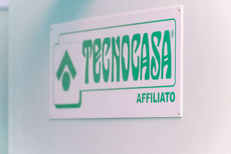 LUGO (RA), ITALY â€“ SEPTEMBER 11, 2018: Dust and dirt covering the TECNOCASA logo on signboard