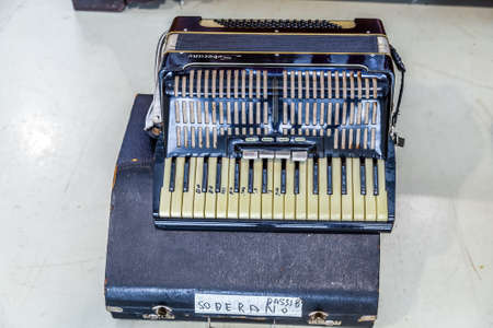 CESENA (FC), ITALY - SEPTEMBER 16, 2018: dust and dirt covering  old accordion at antiques fair in...
