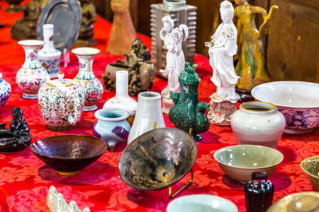 CESENA (FC), ITALY - SEPTEMBER 16, 2018: lights enlightening Chinese pottery at antiques fair in Cesenaのeditorial素材
