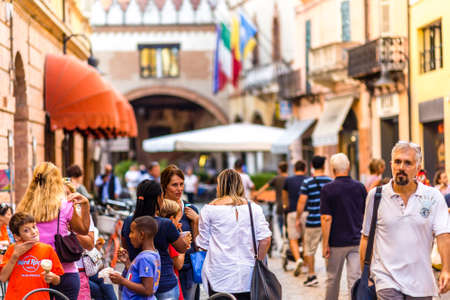 RAVENNA, ITALY - SEPTEMBER 19, 2018: tourists eating ice cream and walking in historical center of Ravennaのeditorial素材