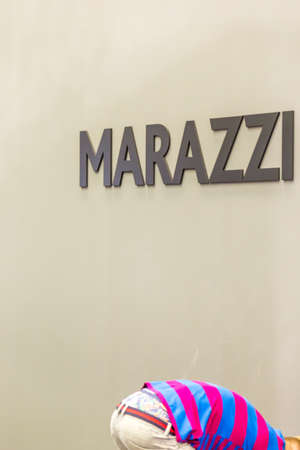 BOLOGNA (ITALY), SEPTEMBER 26, 2018: light is enlightening man with colorful pants under MARAZZI...