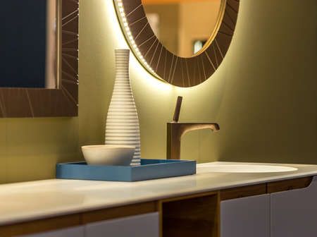 chrome faucet on white marble washbasinの写真素材