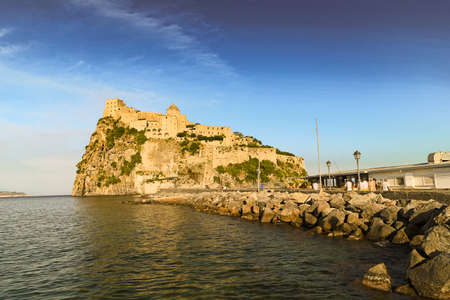 ISCHIA  (NA), ITALY - SEPTEMBER 20, 2012: sunset is enlightening Aragonese Castle on Ischia island