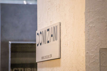 BOLOGNA (ITALY), SEPTEMBER 28, 2018: light is enlightening DOMIZIANI logo at CERSAIE, international exhibition of ceramic tile and bathroom furnishingsのeditorial素材