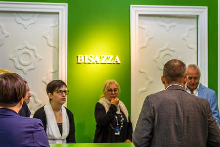 BOLOGNA (ITALY), SEPTEMBER 28, 2018: booth presenters informing visitors at CERSAIE, international...