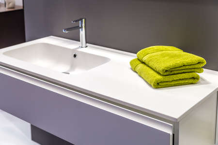 green towels near sink on counter in modern bathroomのeditorial素材