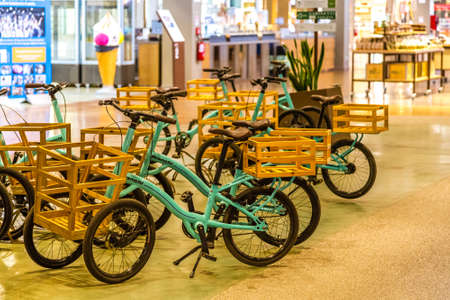 BOLOGNA, ITALY - OCTOBER 2, 2018: lights are enlightening vintage BIANCHI bicycles with shopping basket at FICO EATALY WORLD, the largest agri-food park in the worldのeditorial素材