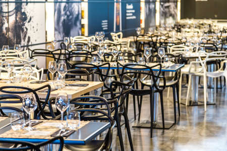 BOLOGNA, ITALY - OCTOBER 2, 2018: lights are enlightening tables and chairs of restaurant at FICO EATALY WORLD, the largest agri-food park in the worldのeditorial素材