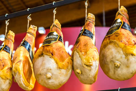 BOLOGNA, ITALY - OCTOBER 2, 2018: lights are enlightening hanging Ruliano Parma hams signed by Heinz Beck at FICO EATALY WORLD, the largest agri-food park in the worldのeditorial素材