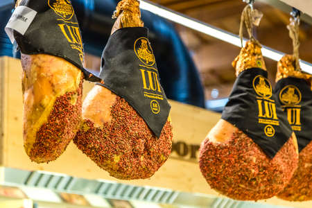BOLOGNA, ITALY - OCTOBER 2, 2018: lights are enlightening hanging Hams of Norcia at FICO EATALY WORLD, the largest agri-food park in the worldのeditorial素材