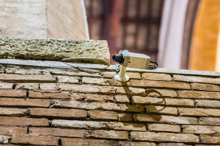 Modern surveillance camera on old brick wallの写真素材