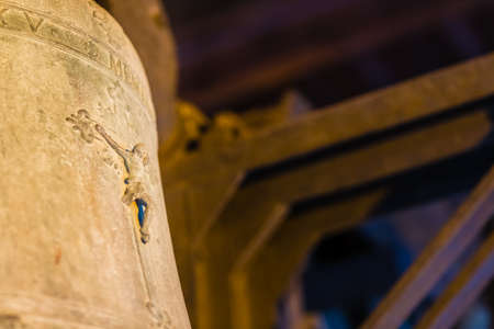 Crucifixion of Jesus Christ on ancient bronze bell in towerの写真素材