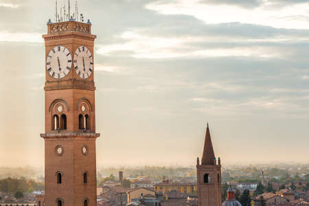 cityscape with ancient clock tower on sky backgroundの写真素材