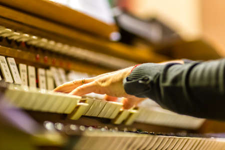 male hands playing organ keyboard in church