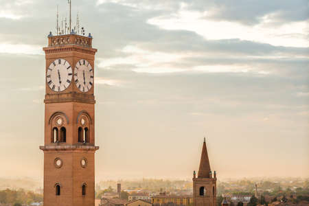 cityscape with ancient clock tower on sky background