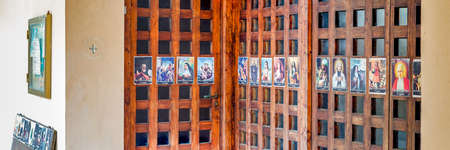 SAN BERNARDINO (RA), ITALY â OCTOBER 31, 2018: The priest put on the entrance of the church the images of the Saints to remind the religious connotation of Halloweenのeditorial素材