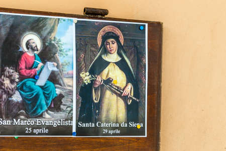 SAN BERNARDINO (RA), ITALY â OCTOBER 31, 2018: The priest put on the entrance of the church the images of the Saints to remind the religious connotation of Halloweenのeditorial素材