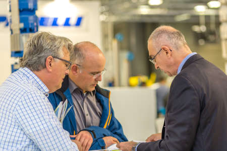 BOLOGNA, ITALY â€“ NOVEMBER 10, 2018:  Booth presenter welcoming business visitors at EIMA...