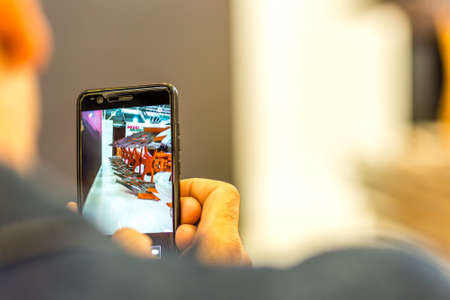 BOLOGNA, ITALY â€“ NOVEMBER 10, 2018: people visiting the fair and shooting photos with mobile...