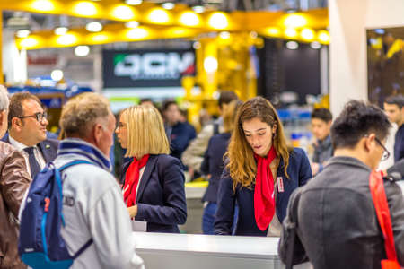 BOLOGNA, ITALY â€“ NOVEMBER 10, 2018:  Booth presenter welcoming business visitors at EIMA...