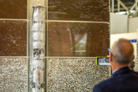 BOLOGNA, ITALY â NOVEMBER 10, 2018: people visiting the fair and shooting photos with mobile phone at EIMA 2018,  International Agricultural and Gardening Machinery Exhibitionのeditorial素材