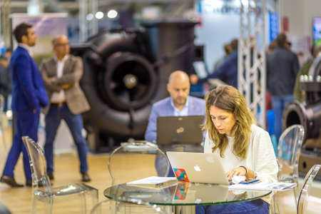 BOLOGNA, ITALY â€“ NOVEMBER 10, 2018: booth presenter waiting for visitors at EIMA 2018, ...