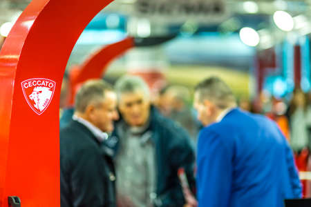 BOLOGNA, ITALY â NOVEMBER 10, 2018:  Booth presenter welcoming business visitors at EIMA 2018,  International Agricultural and Gardening Machinery Exhibitionのeditorial素材