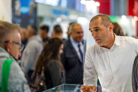 BOLOGNA, ITALY â€“ NOVEMBER 10, 2018:  Booth presenter welcoming business visitors at EIMA...