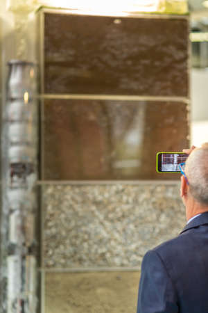 BOLOGNA, ITALY â NOVEMBER 10, 2018: people visiting the fair and shooting photos with mobile phone at EIMA 2018,  International Agricultural and Gardening Machinery Exhibitionのeditorial素材