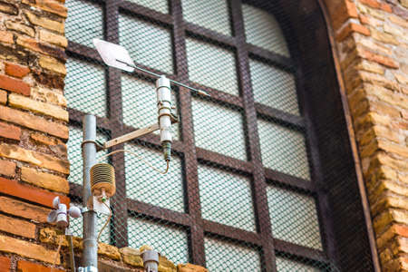 Anemometer on the wall of an ancient church