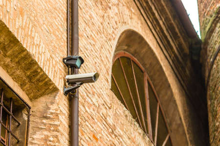 Surveillance cameras with pigeon Dissuader on ancient walls