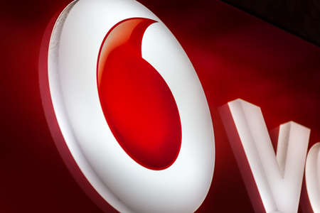 RAVENNA, ITALY - SEPTEMBER 12, 2018: light is enlightening  VODAFONE logo on storefrontのeditorial素材