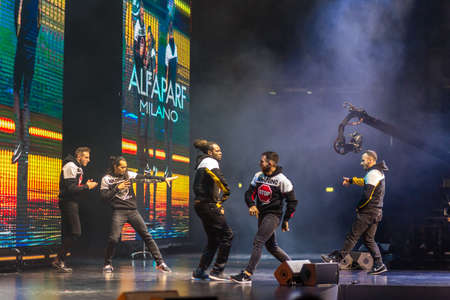 BOLOGNA, ITALY - NOVEMBER 25, 2018: Breakdancers perform on catwalk in theatre during hairstyle show...