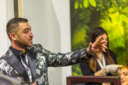 BOLOGNA, ITALY - NOVEMBER 25, 2018: Hairstylist Michele Rinaldi welcoming visitors.のeditorial素材