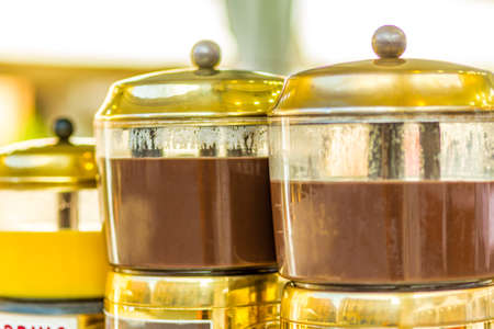 hot chocolate flowing in mixer pots