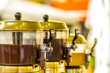 hot chocolate flowing in mixer potsの写真素材