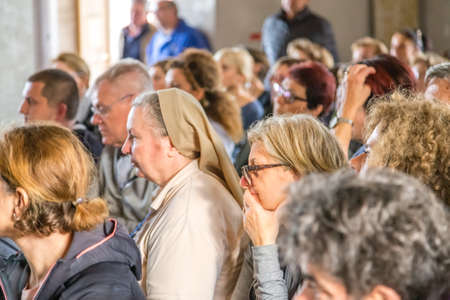 Medjugorje, Bosnia and Herzegovina - November 3, 2018: people praying in church and looking at the altarのeditorial素材